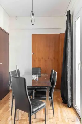 a dining room with a wooden table and chairs at 2BDR Boutique Full Apt in Plaka (BIG BALCONY) in Athens