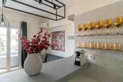 a vase with flowers sitting on a counter in a kitchen at 2BDR Boutique Full Apt in Plaka (BIG BALCONY) in Athens