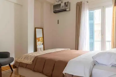 a bedroom with a bed and a mirror and a window at 2BDR Boutique Full Apt in Plaka (BIG BALCONY) in Athens