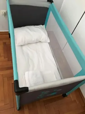 a small crib with a bed in a room at 2BDR Boutique Full Apt in Plaka (BIG BALCONY) in Athens