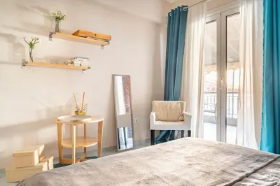 a bedroom with a bed and a table and a window at OpenAir HOT TUB/Big Balcony/Great Boutique Apt in Athens