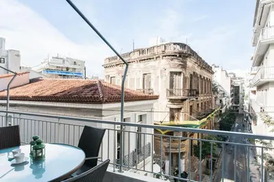 a balcony with a table and a view of a city at OpenAir HOT TUB/Big Balcony/Great Boutique Apt in Athens