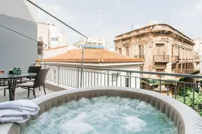 a hot tub on the balcony of a building at OpenAir HOT TUB/Big Balcony/Great Boutique Apt in Athens
