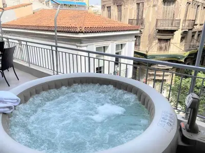 a hot tub on the balcony of a building at OpenAir HOT TUB/Big Balcony/Great Boutique Apt in Athens