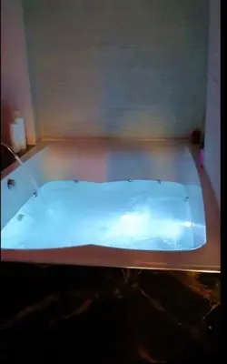 a white bath tub in a room with at Romantic Jacuzzi Apartment in Athens