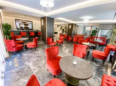 a restaurant with red chairs and tables at Royalty Hotel Athens in Athens