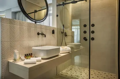 a bathroom with a sink and a shower at Royalty Hotel Athens in Athens
