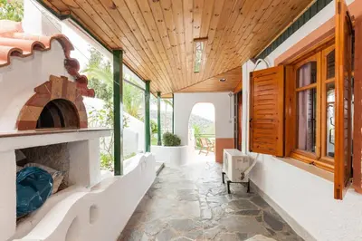 a hallway of a house with a wood ceiling at WHOLE HOUSE NEAR THE BEACH WITH AMAZING VIEW in Kalívia Thorikoú