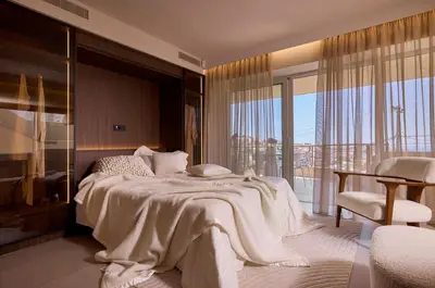 a bedroom with a large bed and a balcony at Grystal Green Properites in Athens
