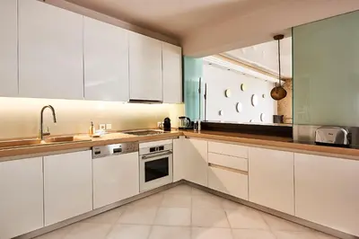a kitchen with white cabinets and a sink at Grystal Green Properites in Athens