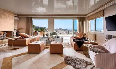 a living room with couches and a large window at Grystal Green Properites in Athens