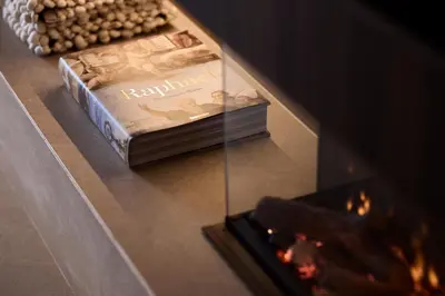 a book sitting on a table next to a fireplace at Grystal Green Properites in Athens