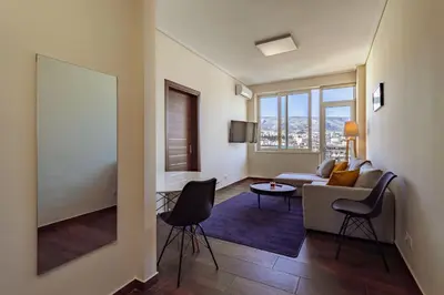 a living room with a couch and a table at Acropolis Comfy Home in the Heart of Athens for 4 by Filos Inc in Athens