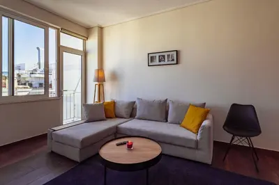 a living room with a couch and a table at Acropolis Comfy Home in the Heart of Athens for 4 by Filos Inc in Athens