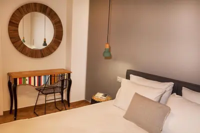 a bedroom with a bed and a mirror and a chair at Central Comfy Modern Flat 2 bedrooms 2 bathrooms in Athens