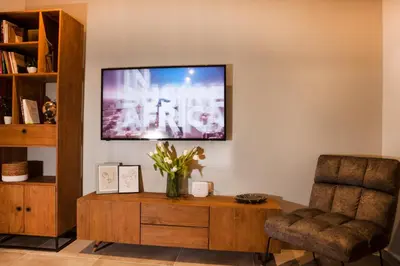 a living room with a television and a chair at Central Comfy Modern Flat 2 bedrooms 2 bathrooms in Athens