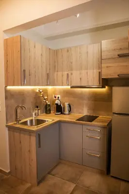 a kitchen with wooden cabinets and a sink at Central Comfy Modern Flat 2 bedrooms 2 bathrooms in Athens
