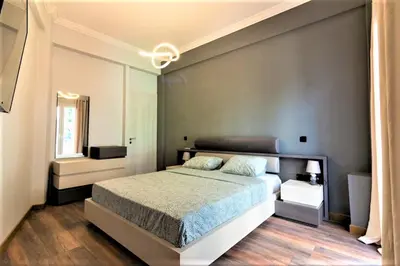 a bedroom with a large bed and a window at Double Romantic Suite in Athens