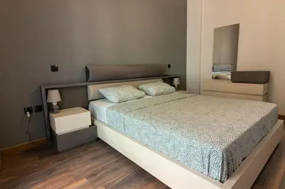 a bedroom with a large bed and a mirror at Double Romantic Suite in Athens