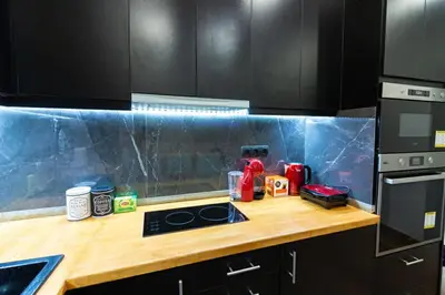 a kitchen with a wooden counter top with a stove at Double Romantic Suite in Athens