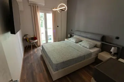 a bedroom with a bed and a large window at Double Romantic Suite in Athens