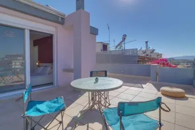 a patio with a table and two chairs on a balcony at Studio with private terrace and view of Acropolis! in Athens
