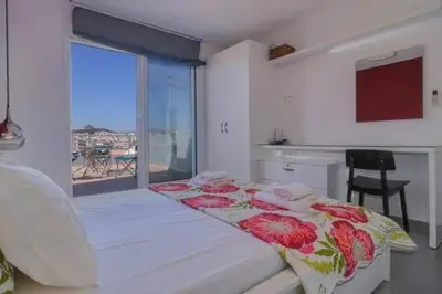 a bedroom with a bed and a window with a view at Studio with private terrace and view of Acropolis! in Athens