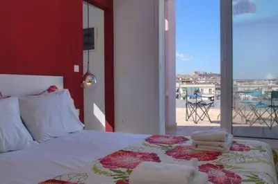 a bedroom with a bed with a view of the beach at Studio with private terrace and view of Acropolis! in Athens