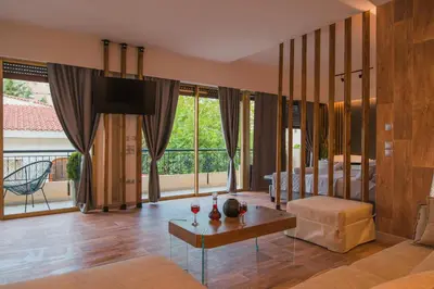 a living room with a tv and a couch and a table at NOHO Boutique , premium living Lazeon 7 in Athens