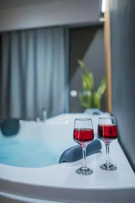 two glasses of red wine sitting on a table at NOHO Boutique , premium living Lazeon 7 in Athens