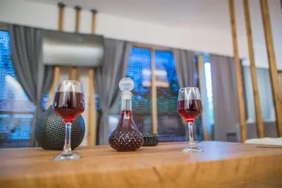 two glasses of red wine sitting on a wooden table at NOHO Boutique , premium living Lazeon 7 in Athens