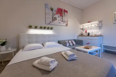 a bedroom with a large bed with towels on it at Athens Acropolis House in Athens