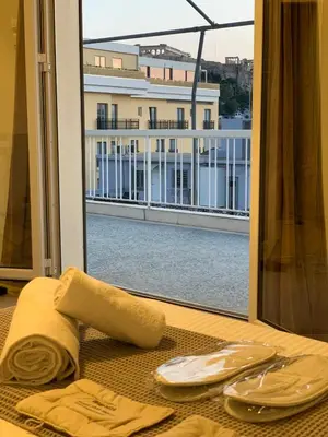 a table with a towel and plates and a window at Athens Acropolis House in Athens
