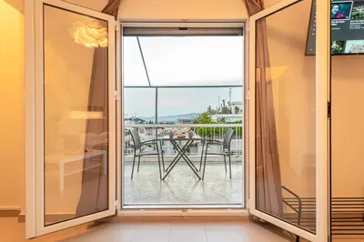 a sliding glass door with a view of a patio at Athens Acropolis House in Athens