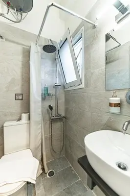 a bathroom with a shower and a sink at Athens Acropolis House in Athens