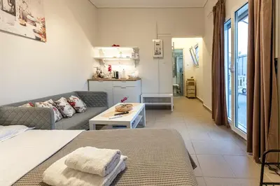 a living room with a couch and a table at Athens Acropolis House in Athens