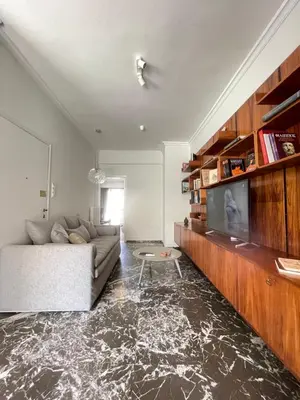 a living room with a couch and a flat screen tv at Plato - Acropolis Residence Apartment in Athens