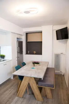 a dining room with a table and chairs at Stylish, comfortable, basement loft-like apartment with amenities in Athens