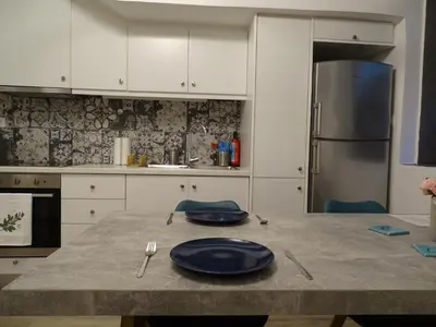 a kitchen with a table with blue plates on it at Stylish, comfortable, basement loft-like apartment with amenities in Athens