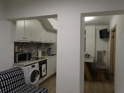a kitchen with a washer and dryer in a room at Stylish, comfortable, basement loft-like apartment with amenities in Athens