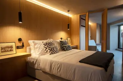 a bedroom with a large white bed with pillows at Groovy in Athens