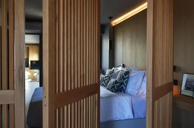 a door leading into a bedroom with a bed at Groovy in Athens