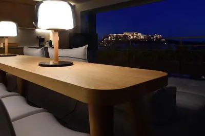 a wooden table with two lamps on top of a room at Groovy in Athens