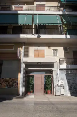 a building with a pink door and a balcony at Acropolis view and 360 degrees in Athens