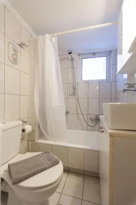 a bathroom with a toilet and a shower and a sink at Acropolis view and 360 degrees in Athens
