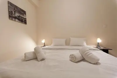 a bedroom with two beds with towels on them at Acropolis view and 360 degrees in Athens