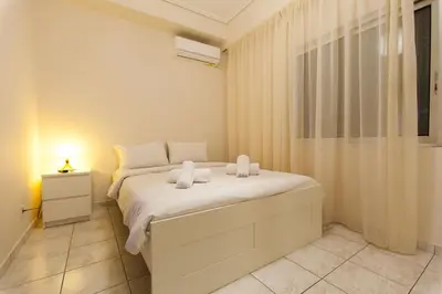 a bedroom with a bed with two towels on it at Acropolis view and 360 degrees in Athens