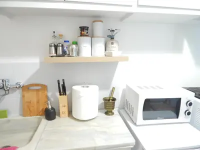 a kitchen with a microwave and a counter with spices at Feels Like Home 2 in Athens