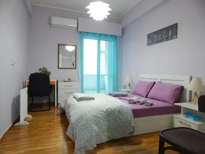 a bedroom with a purple bed and a desk at Feels Like Home 2 in Athens