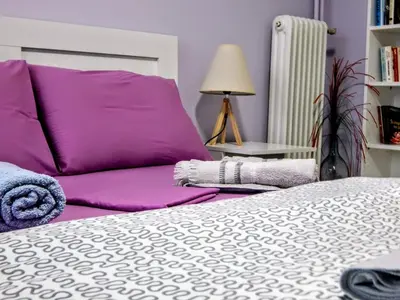 a bedroom with a bed and a purple pillow at Feels Like Home 2 in Athens